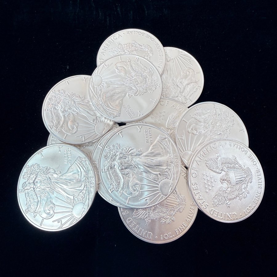 A pile of one-ounce American Silver Eagle coins